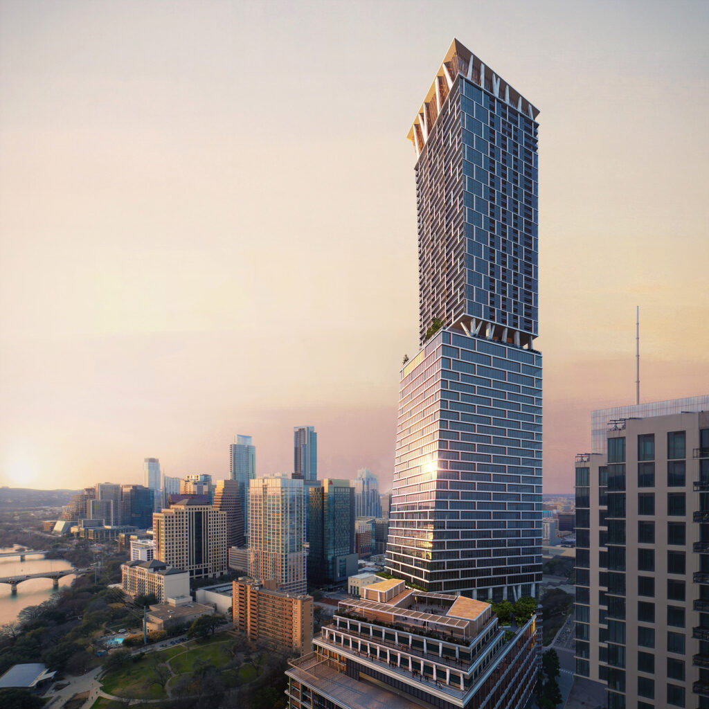 Aerial view of a modern cityscape at sunset, featuring a tall, uniquely designed skyscraper with staggered sections and green terraces. Surrounding buildings and a river are visible under a warm, glowing sky.